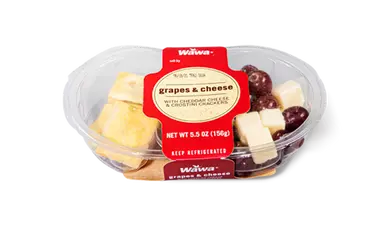 Grapes, cheese cubes, and crackers arranged on a plate.